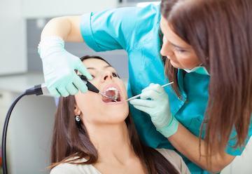 a lady doing dental procedure