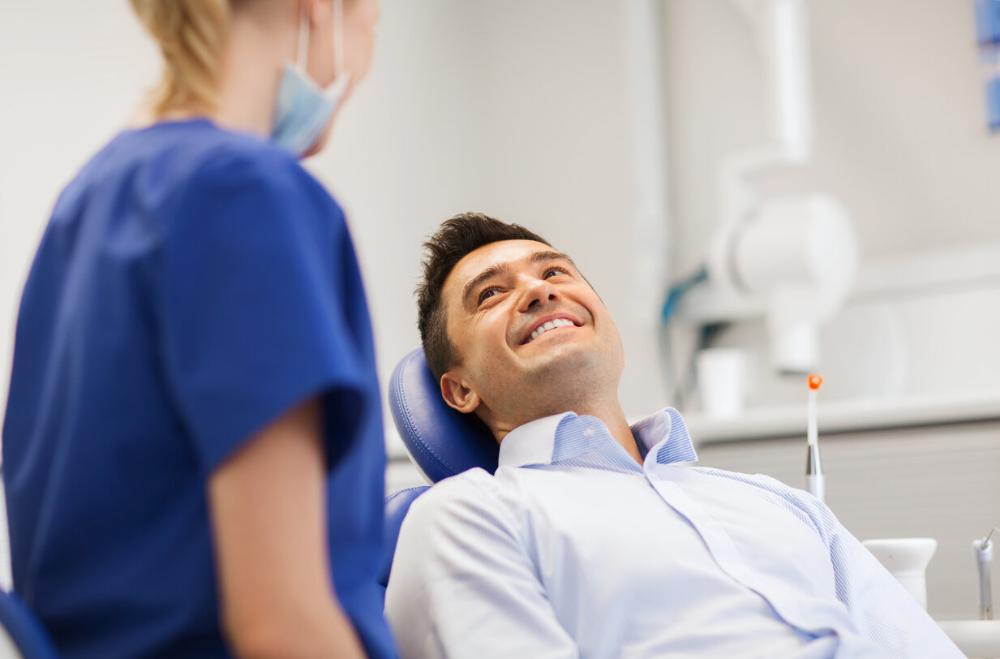 man smiling in dental chair in troy