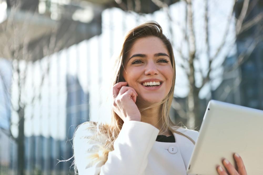 woman smiling while talking on phone