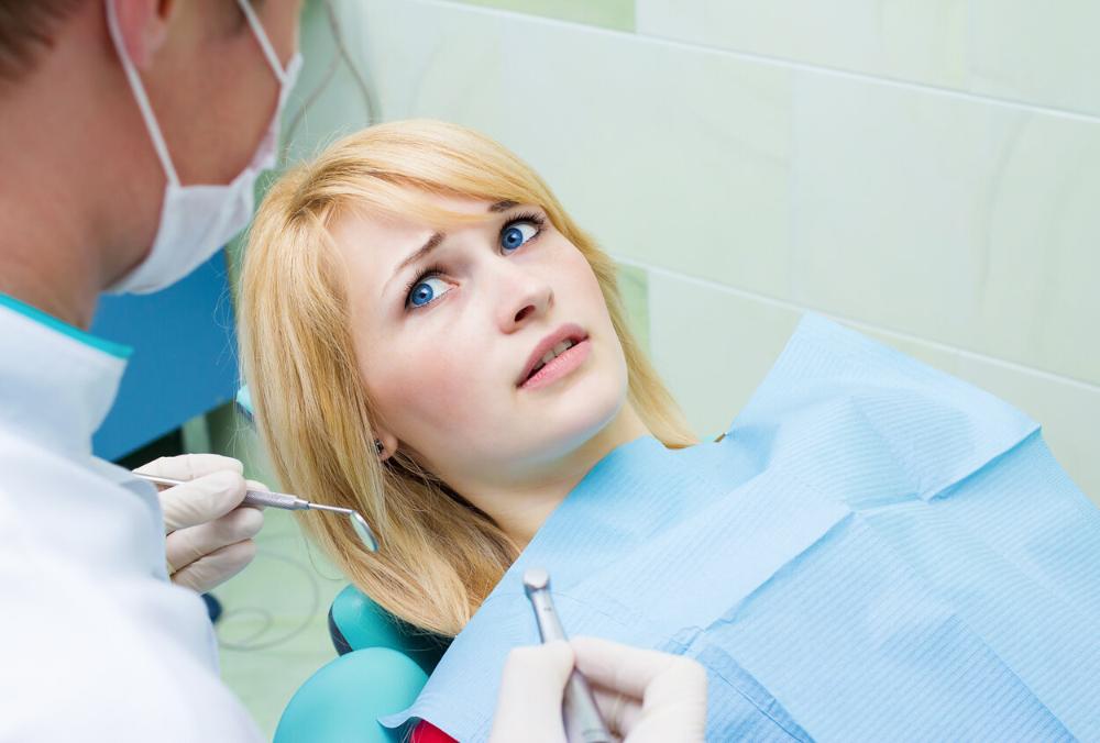 nervous woman sitting dental chair in troy