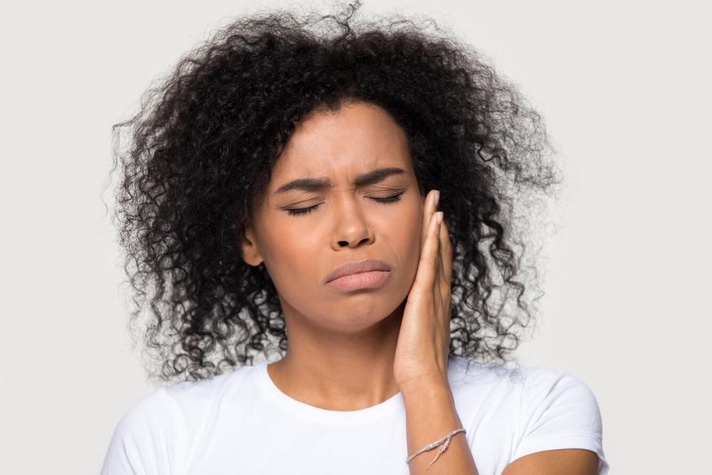 woman holding jaw from sensitive teeth