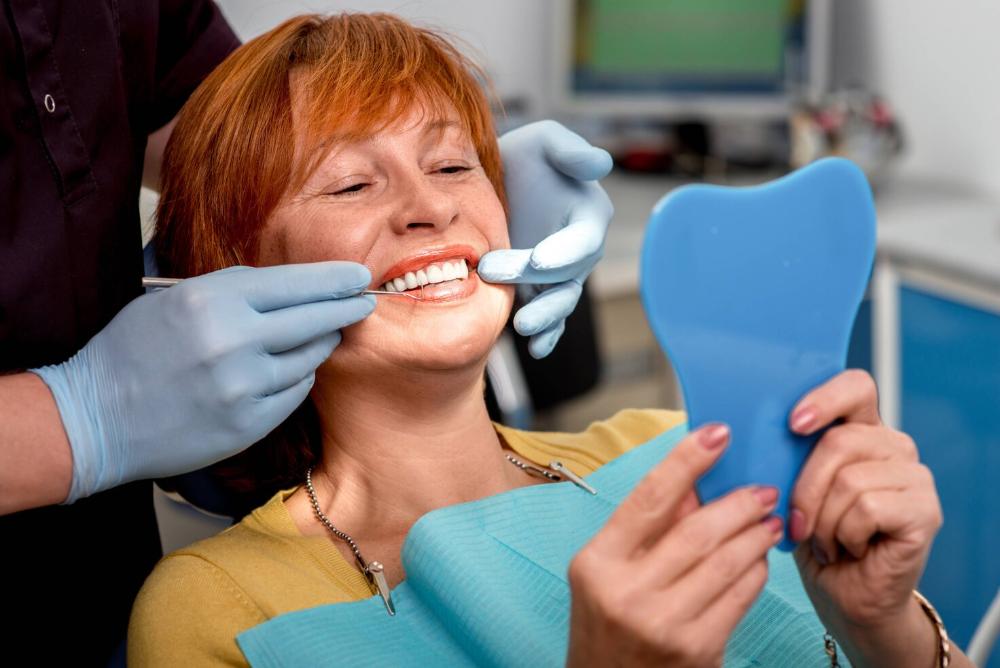 woman smiling in dental chair in troy