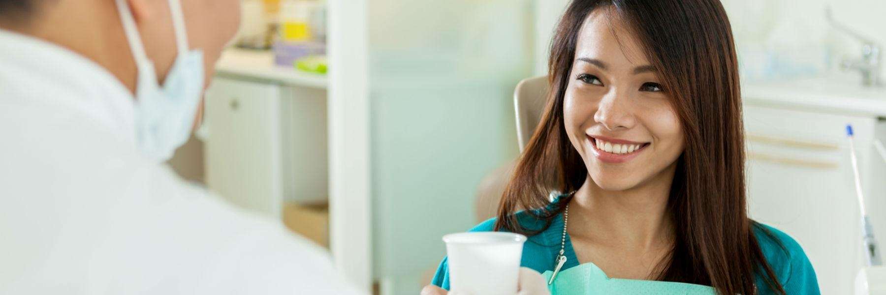 girl in the clinic inquiring about front teeth dental crowns