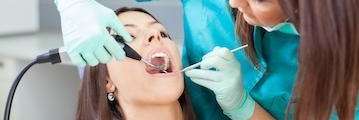 dentist in troy preparing a girl's mouth for root canal treatment
