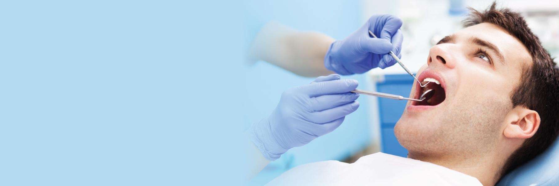 man under dental exam in troy ny