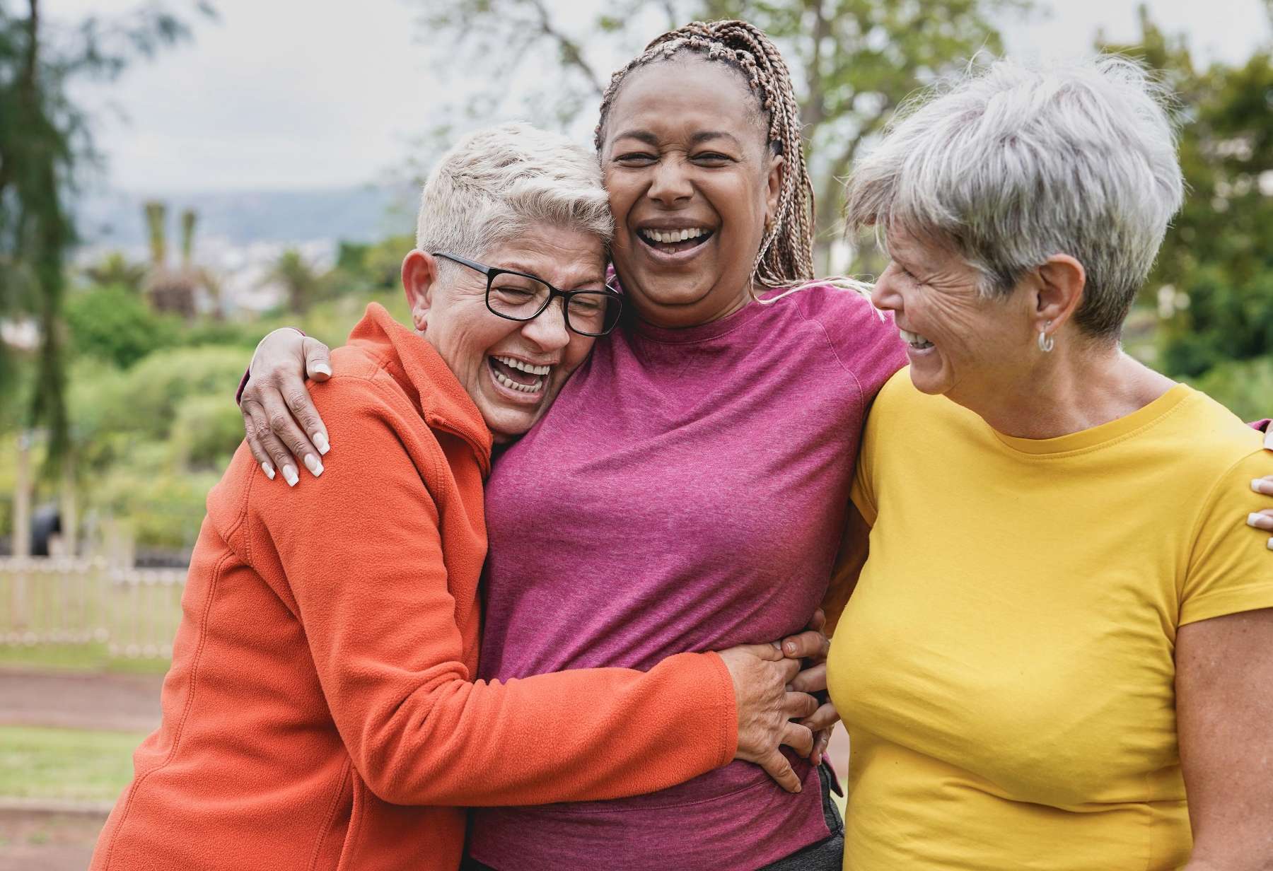 Three women in Troy NY confidently laughing with each other