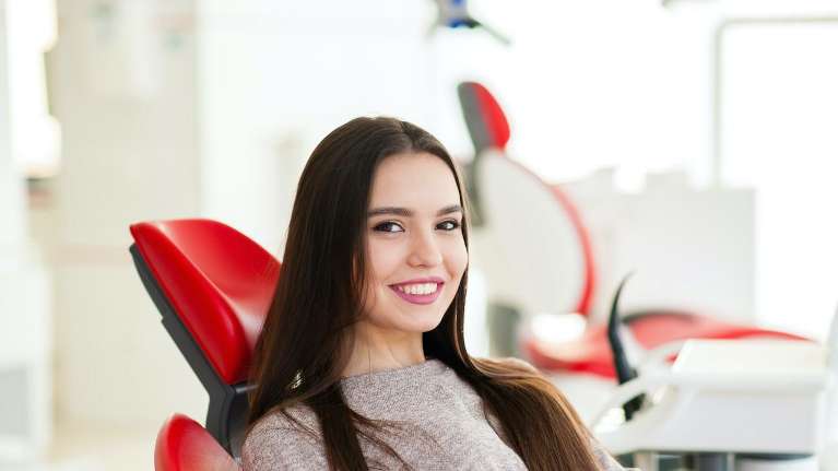 person in the dental office in troy ny for dental crowns