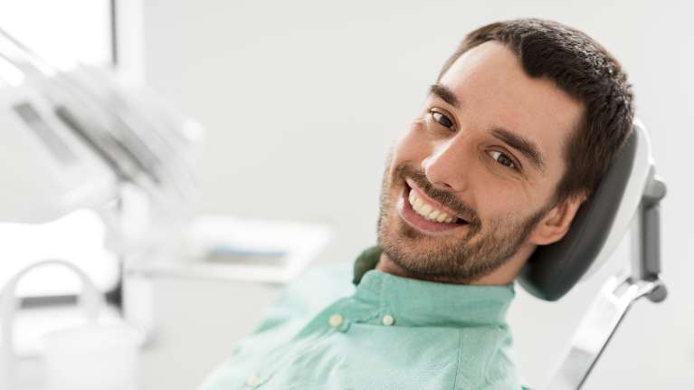 A man sitting comfortably on a dental chair